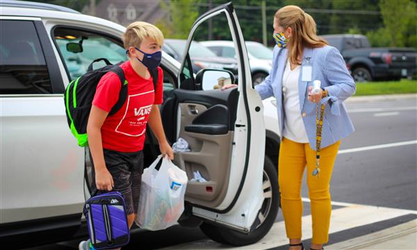 student gets out of car